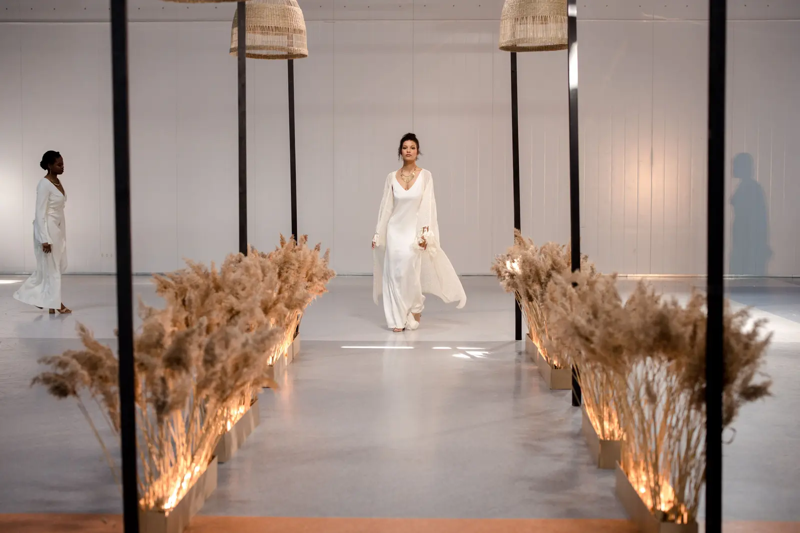 Models walking on a professionally lit fashion runway